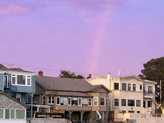 This is the house, the top unit is this listing. The sun room and primary bedroom overlook the lagoon.