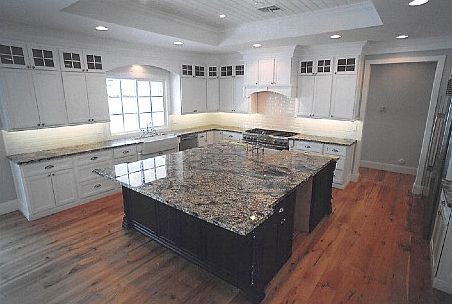 Huge inviting kitchen. Granite island. Under cabinet lighting