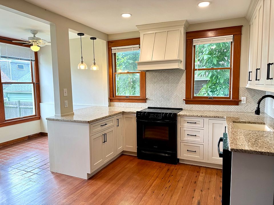 recently renovated kitchen with bench seating overhand and sun drenched breakfast nook.