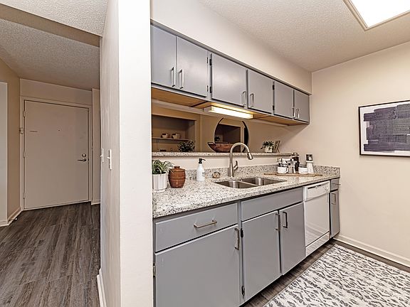 Kitchen with granite counters and hardwood-style flooring