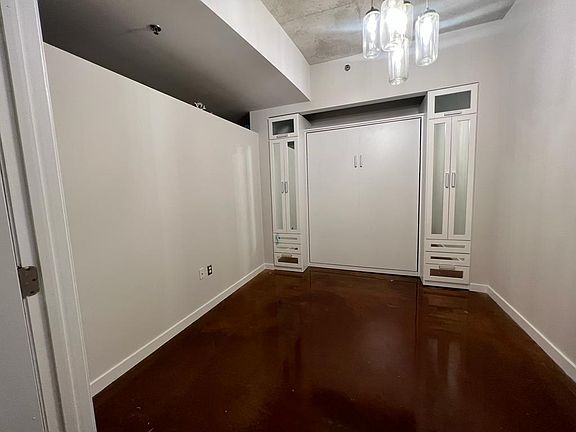 Bedroom or office with fully custom California Closets murphy bed and closet