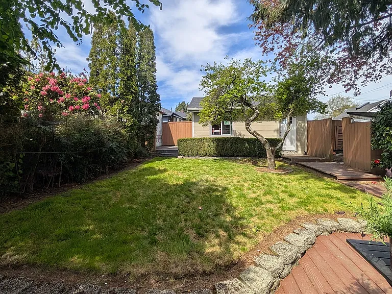 Enjoy a Large, fully fenced yard with new decking. (Detached 1-car garage for parking and extra storage)