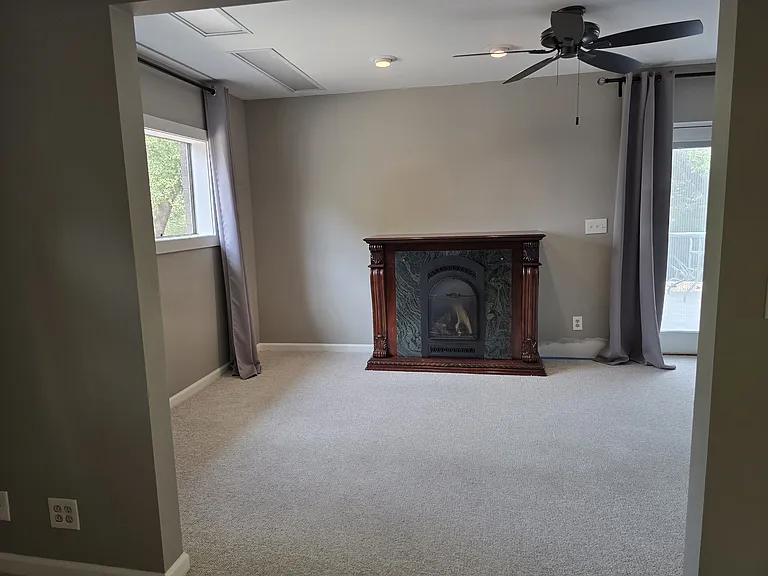 Looking from Bedroom into Living Space with propane fireplace on thermostat and dimmable accent lighting as well as florescent lighting.