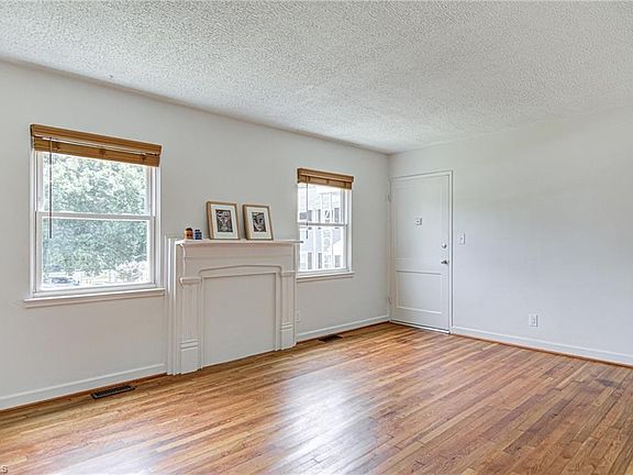 View of the large living room and front entry door.