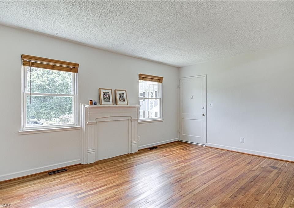 View of the large living room and front entry door.