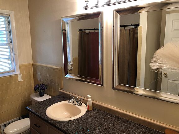 Hall bath with ceramic tile floor and shower