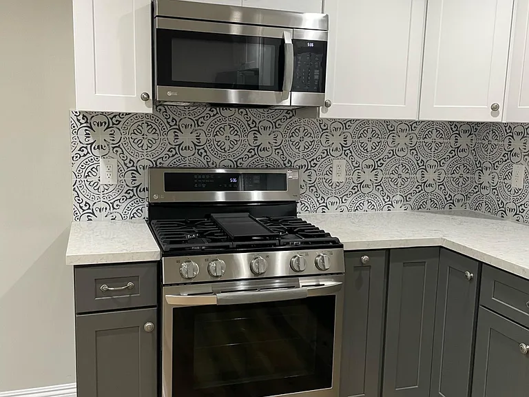 Stove, microwave hood, brand new cabinets with soft closing. Built in spice cabinet and lazy susan in corner cabinet.