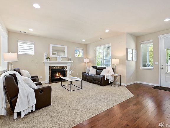 Family room with walls of windows, lots of light & gas fireplace. Prewired for surround sound.