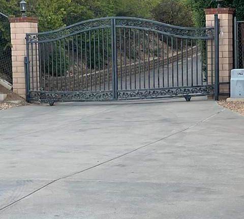 Main gate leading to private road. Not visible from main street, very safe and quiet. Touch pad and remote. Gate was recently tuned up, has new wheels, motor and chain to provide safe and smooth operation.