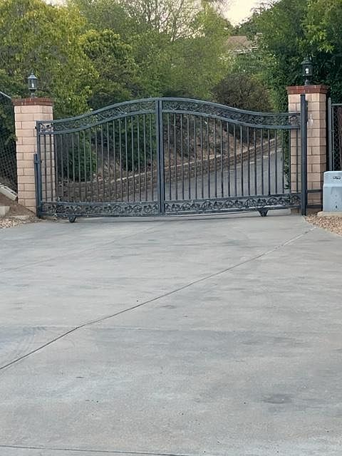 Main gate leading to private road. Not visible from main street, very safe and quiet. Touch pad and remote. Gate was recently tuned up, has new wheels, motor and chain to provide safe and smooth operation.