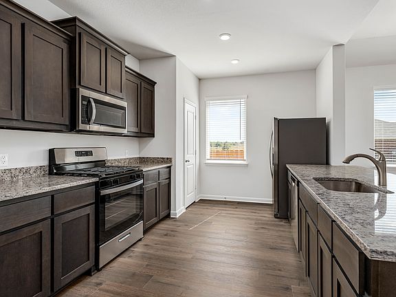 The kitchen has sprawling granite countertops.