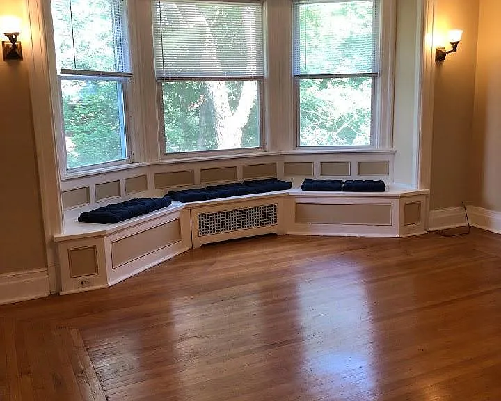 Main room, bay window with seating offers plenty of natural lighting, hardwood floors