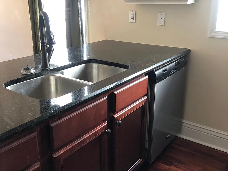 Kitchen features all stainless steel appliances and granite countertops. Dishwasher included in addition to the standard appliance package; apartment now painted light grey