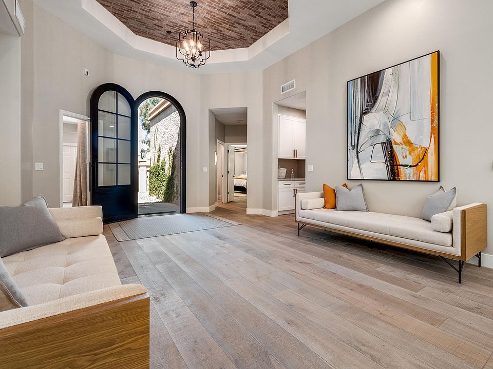 Incredible original canvas paintings and the most stunning daybeds from Bungalow (a very upscale Scottsdale furniture boutique) flank the dramatic entry way.