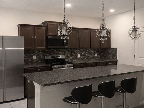 Kitchen island with refrigerator, microwave, and dishwasher included.