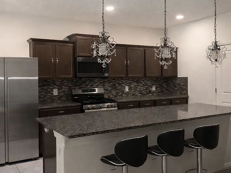 Kitchen island with refrigerator, microwave, and dishwasher included.