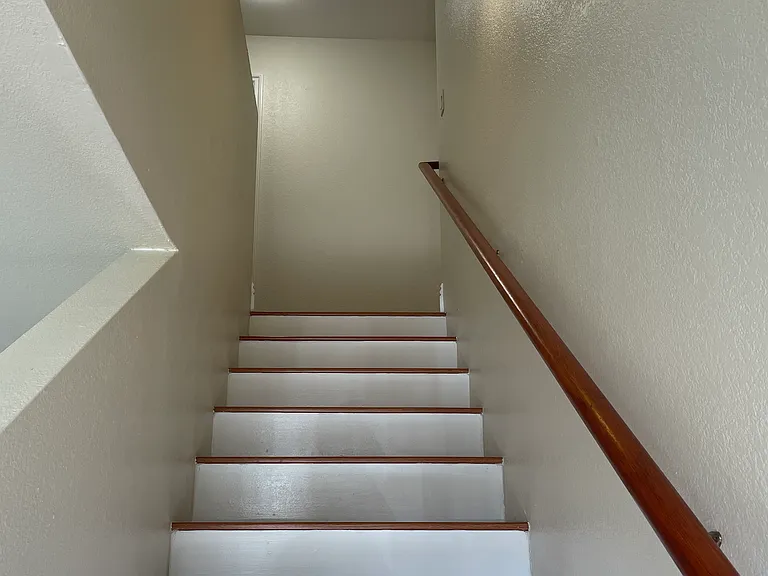 Staircase to bedrooms and full bathroom