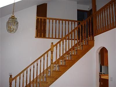 Dramatic solid oak staircase surrounding the living room