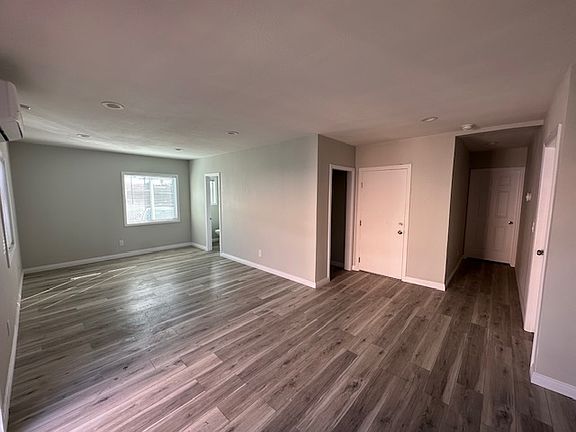 This photo illustrates the seamless flow between the kitchen and the living area, creating an open-concept space perfect for both everyday living and entertaining. The layout allows for easy interaction between the two areas.
