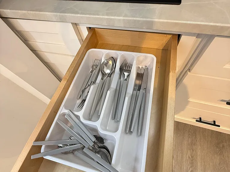 Includes full cutlery set: spoons, forks, and knives.
