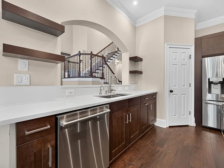 floating shelves, microwave in island, top of the line dishwasher, storage pantry with built ins