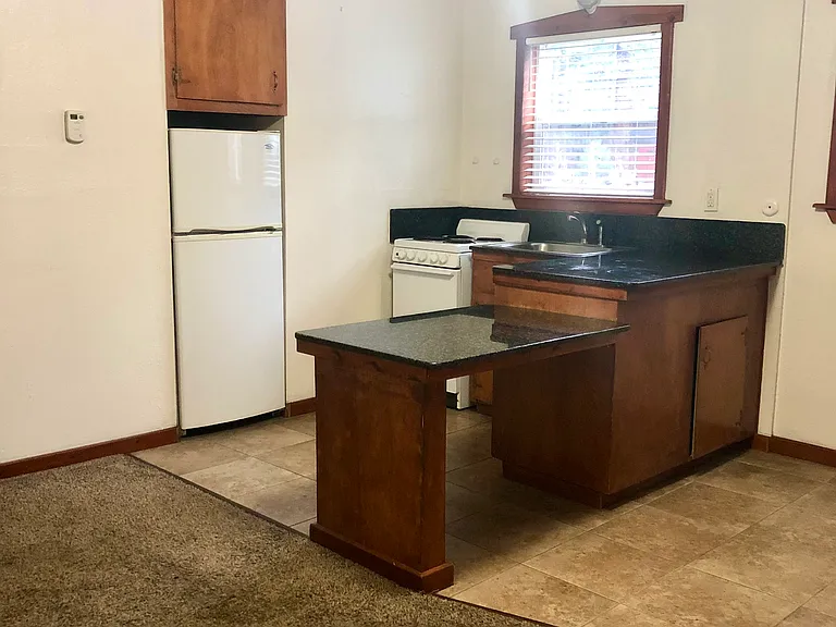 Tiled area for a dining table and carpeted area for living room!