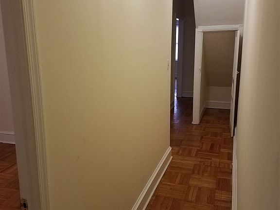 Hallway looking from Bathroom towards living room. Bedrooms