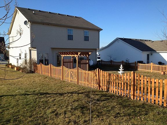 Beautiful fence and fountain in backyard.