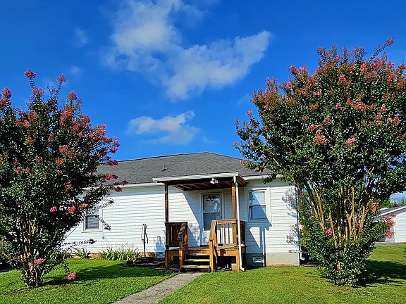 Covered side porch with entrance to the kitchen.