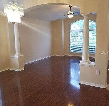 Formal living/dining room combo with beautiful arches and columns.