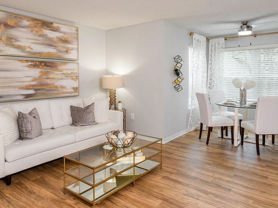 Bright, open-concept living and dining area featuring wood-style flooring and plenty of natural lightperfect for entertaining or relaxing.