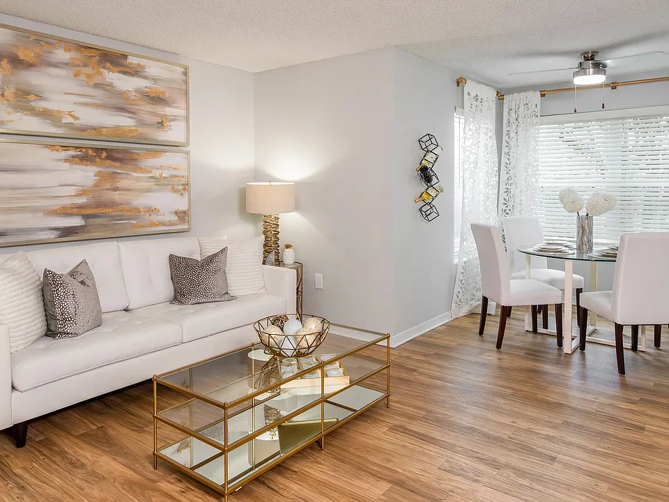 Bright, open-concept living and dining area featuring wood-style flooring and plenty of natural lightperfect for entertaining or relaxing.
