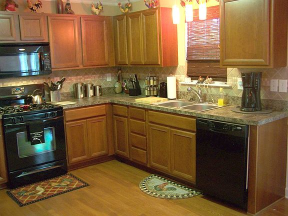 Upgraded cheery cabinets in kitchen