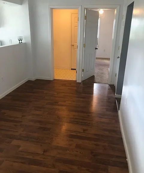 dinning room with kitchen off to your left and 1/2 bath in front