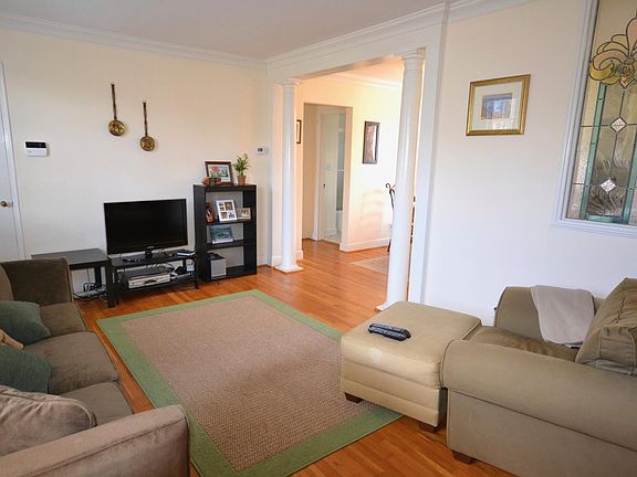 Living Room with stained glass and columns and a coat closet