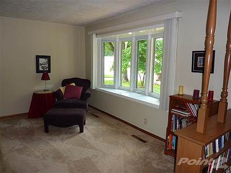 Large bay window gives wonderful light for this living area.  All walls are painted in light, tasteful colors.