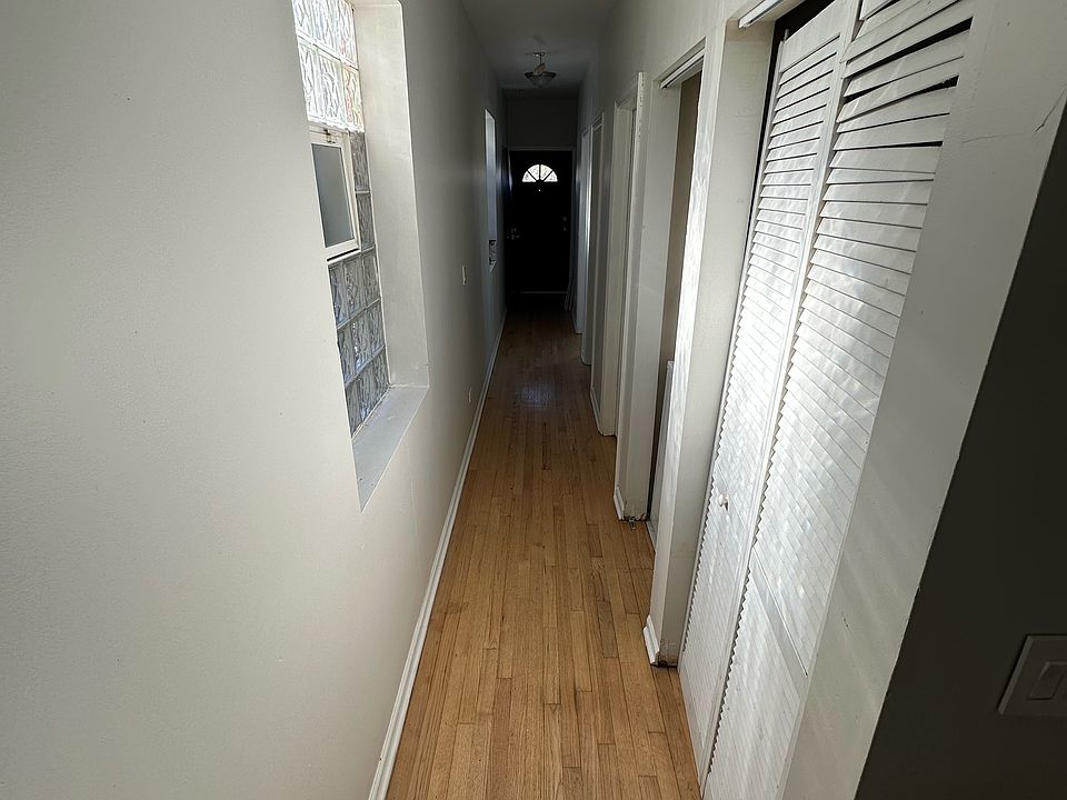 Hallway from Front Entryway to 3 Bedrooms and Hallway Bathroom and Master Bathroom leading to Rear Exit and Parking lot