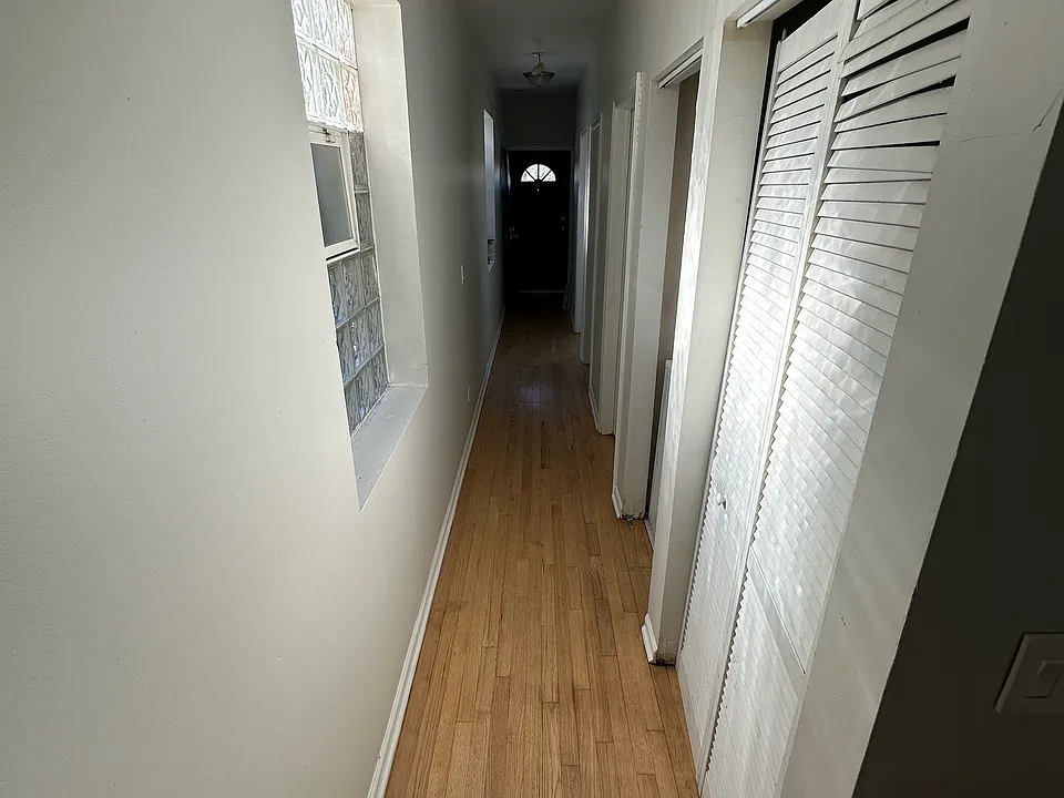 Hallway from Front Entryway to 3 Bedrooms and Hallway Bathroom and Master Bathroom leading to Rear Exit and Parking lot