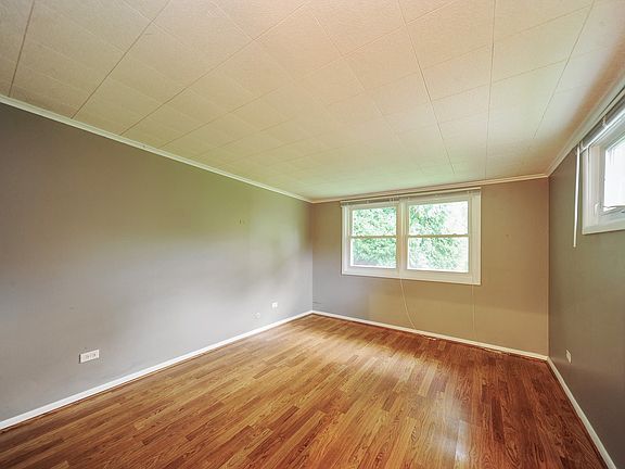Nice sized master bedroom with wood laminate floor