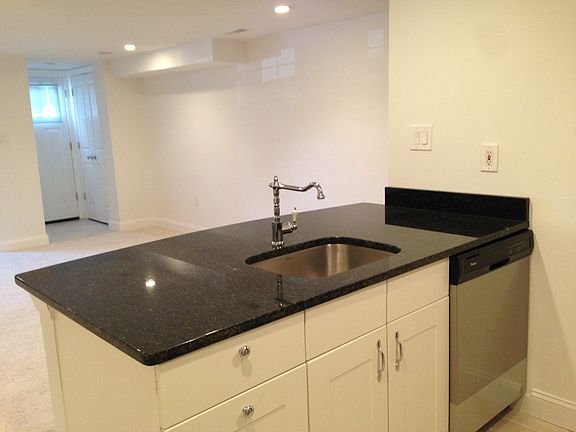 Brand new kitchen with granite countertops (and bar) and dis