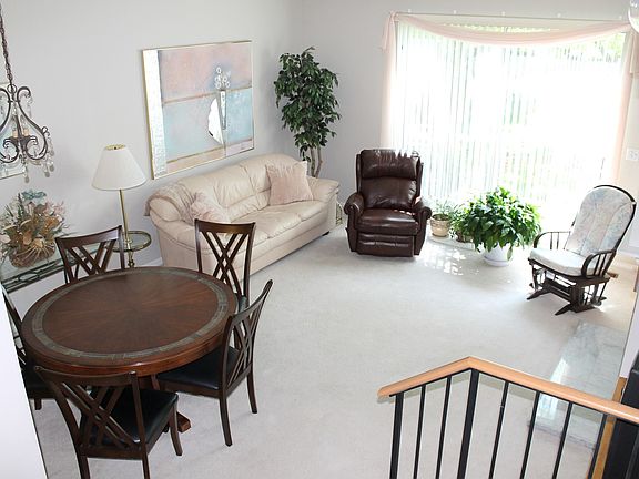 Beautiful open Living/Dining Room with Brick Fireplace and Slider to the Patio.