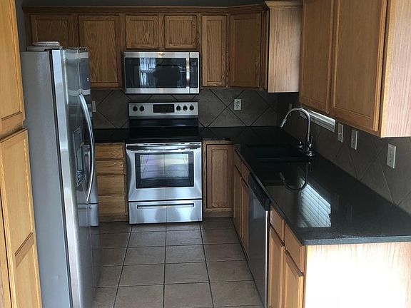 New granite countertops and stainless steel kitchen applianc