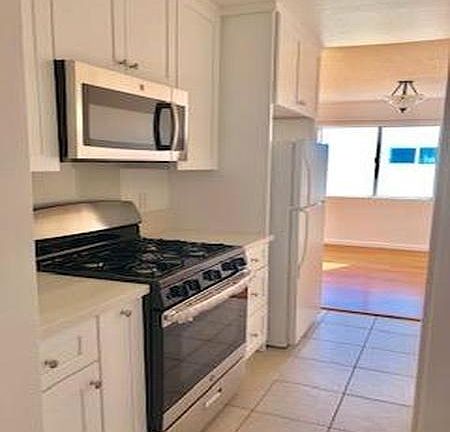 Newly remodeled kitchen with shaker cabinets and quartz counter tops