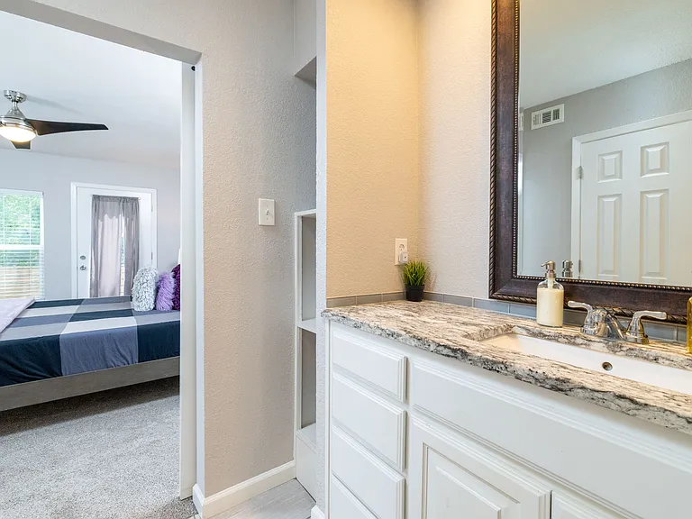 Bathroom 2 with walk-in shower and sink.