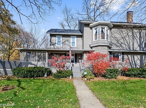 Side view of home with side entry and screened in porch.