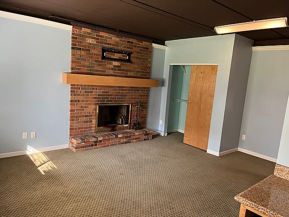 Living area with fireplace and closet
