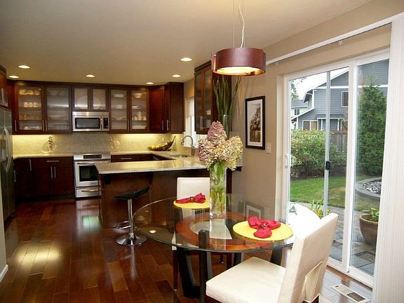 This is the view of the kitchen and dining area along with a view of the slider and back yard. You can see it's a great layout for everyday living. (Aren't the floors beautiful?!)