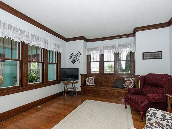 Inviting living room with hardwood floors and wonderful windows for natural light.