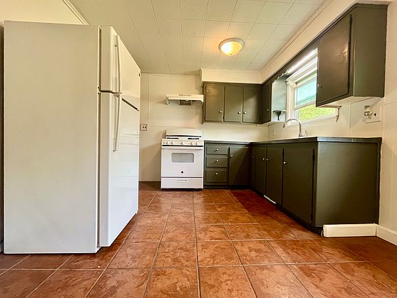 Kitchen with GE Fridge and GE Gas Stove
