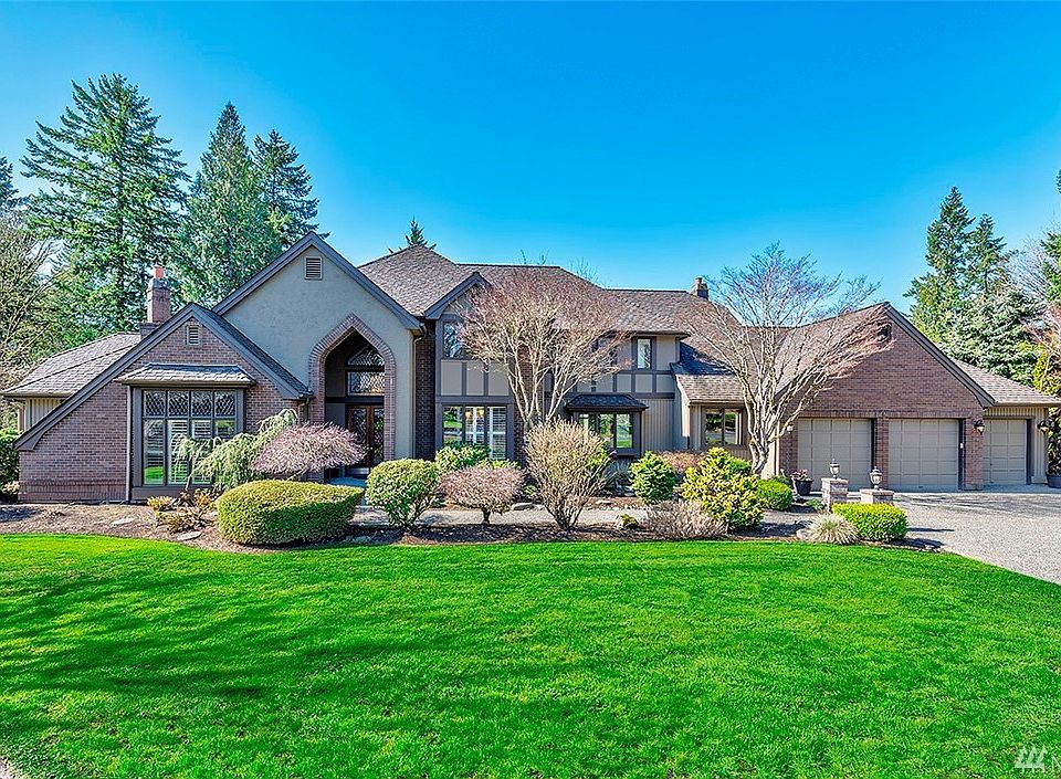 Gorgeous Tudor Style Home Located In The Premier Bear Creek Country Club Golf Course Neighborhood.  Heated 5-Car Garage With Heated Upper Level Garage Storage Room....You Have To See It To Believe It!